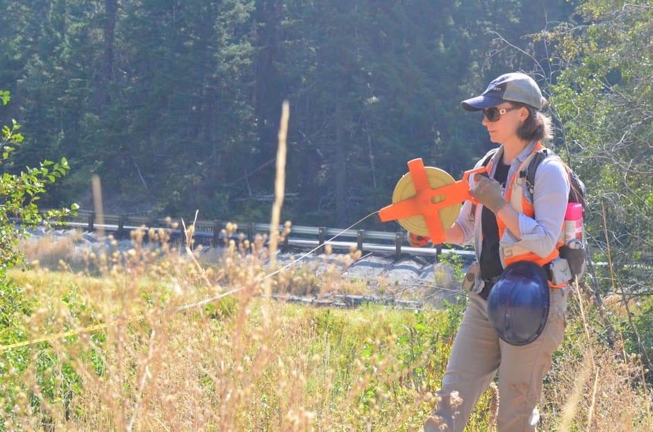 Rebecca Wassel, a biologist who helped design the project, helps mark where the creek is going to run after the culvert gets replaced.