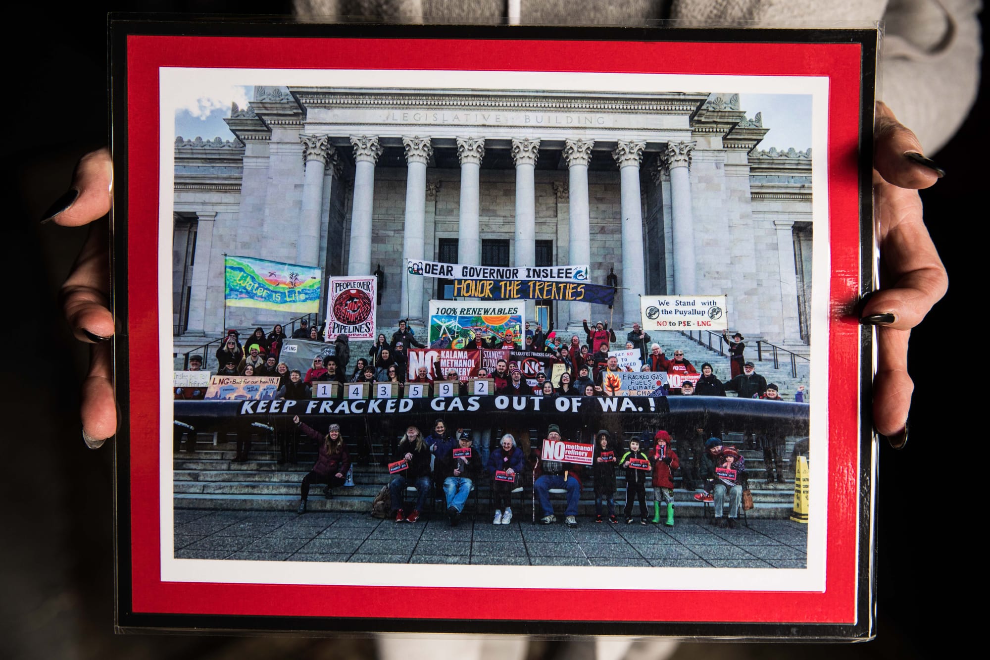 A photo of protesters gathered on the steps of the Washington state capitol.