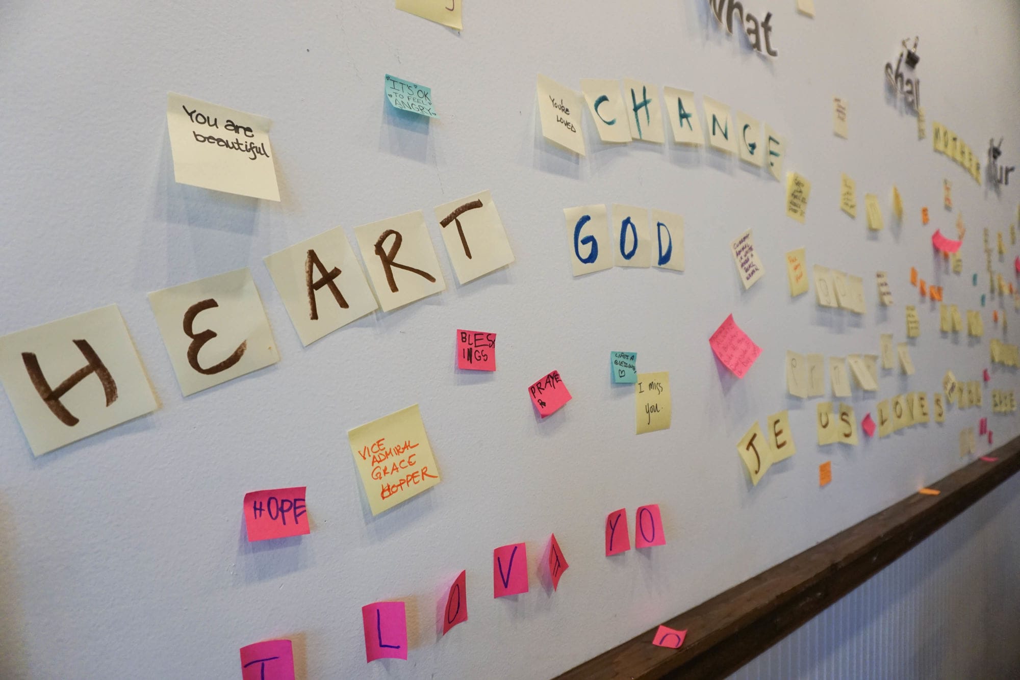 A wall full of positive Post-It notes at Aurora Commons