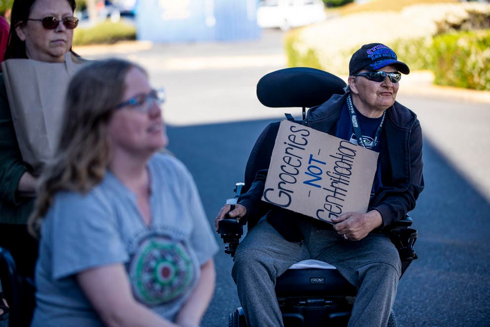 Gina holds a sign in a rally