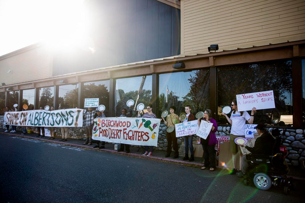 A rally outside of a closed grocery store