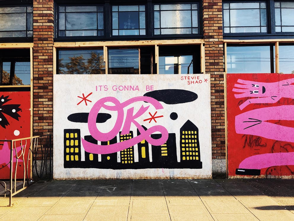 Pink mural with black buildings