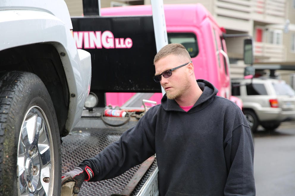 A man stands next to a truck