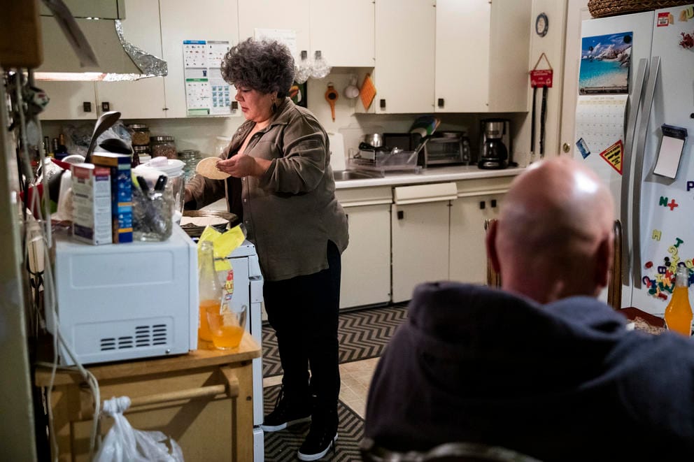 Irma cooks food at her stove