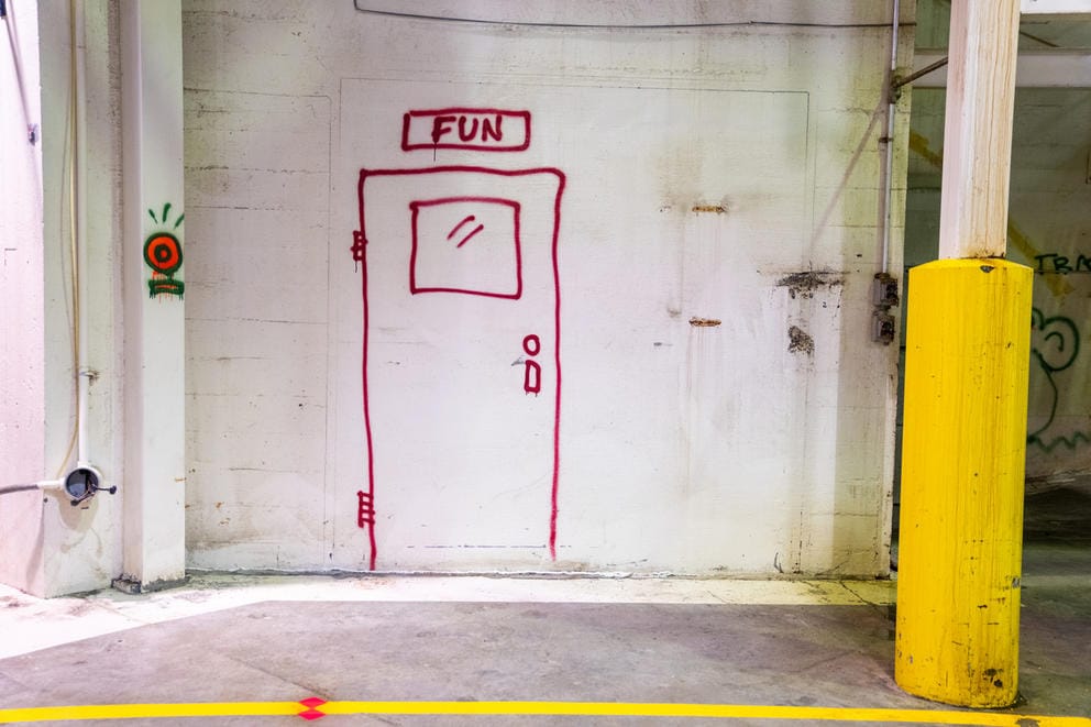 White wall with red paint - in the shape of a door - spraypainted on it