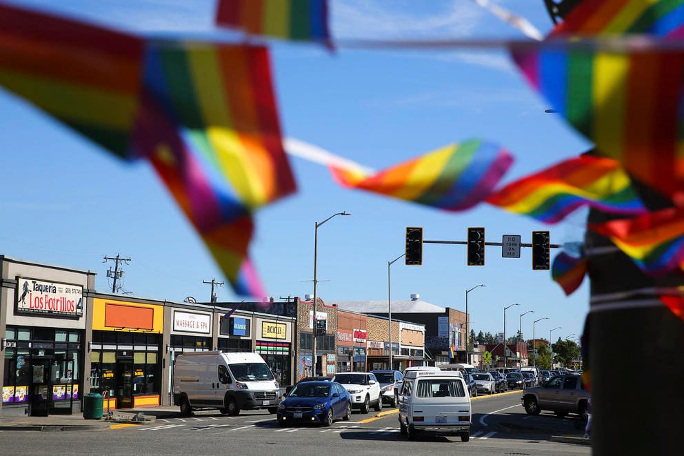 Rainbow flags hang above 16th Avenue SW