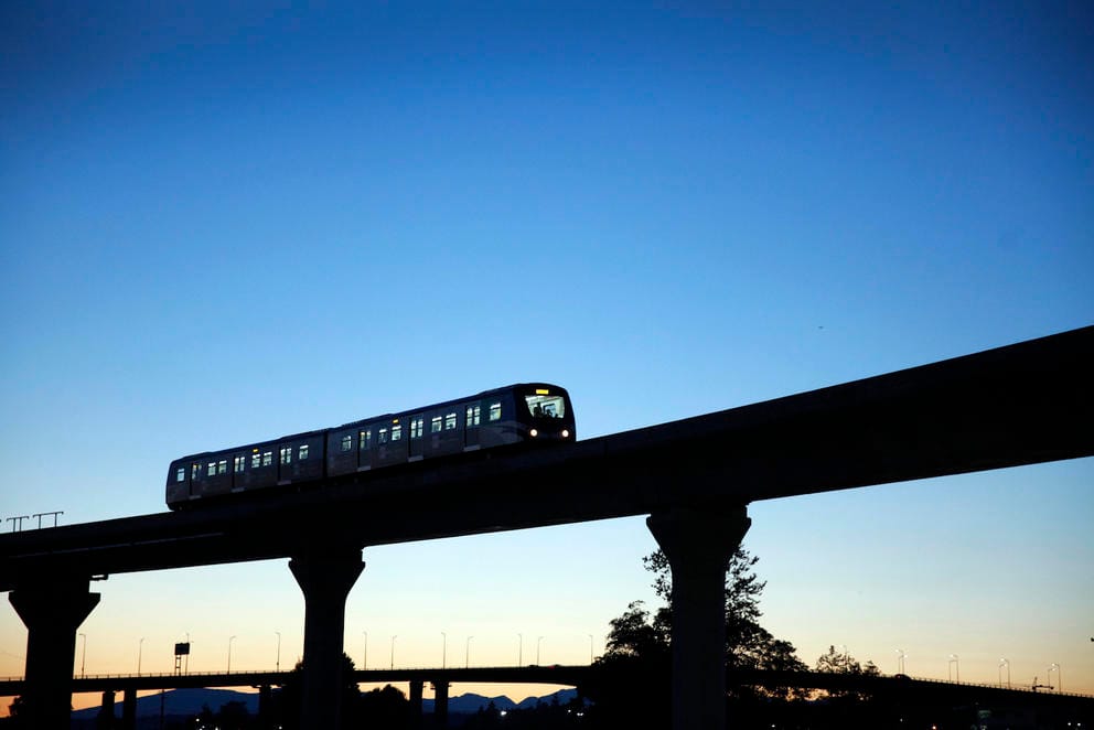 An elevated train under a darkening sky