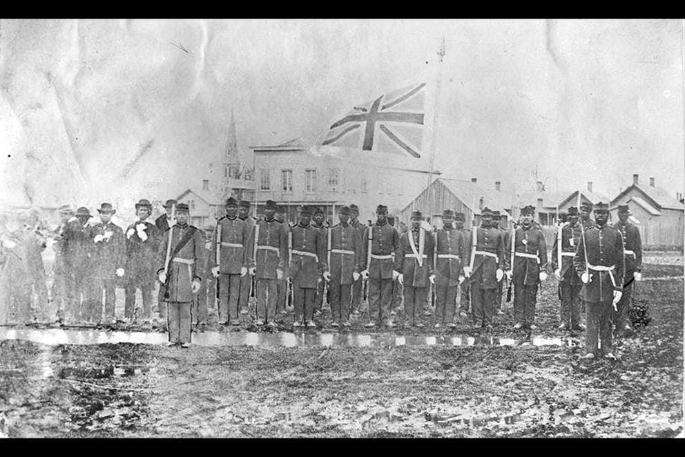 Old photo of a group of black soldiers.