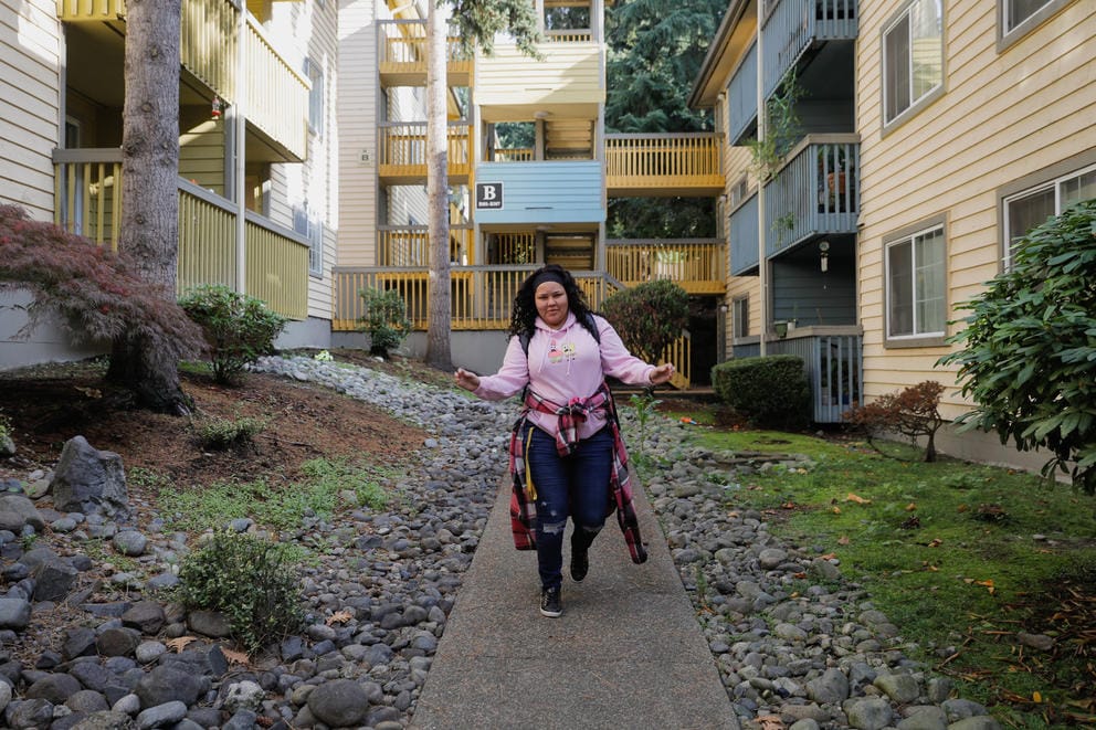 Janell Braxton leaves along the walkway to her apartment building.
