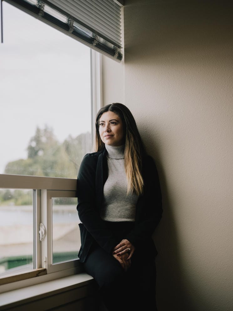 Sheala Anderson poses for a portrait in a corner window