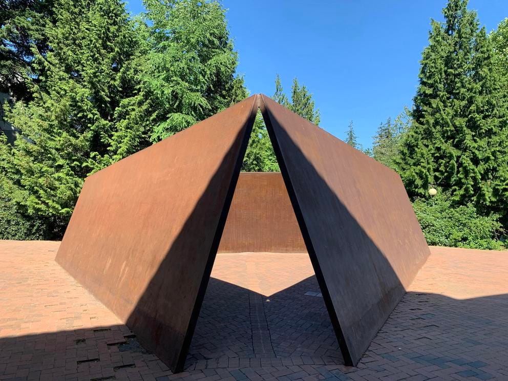 photo of a rusted steel sculpture with sharp triangular angles