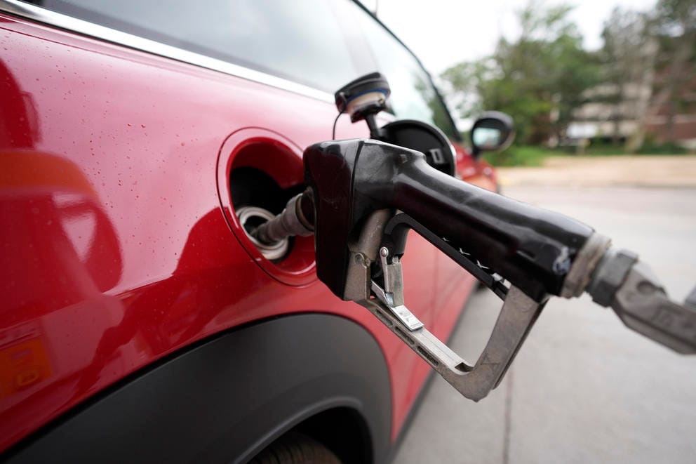 a motorist fills up the tank of a vehicle
