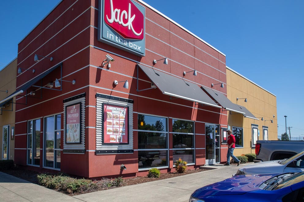 The outside of a the fast food resturant Jack in the Box with a blue sky.