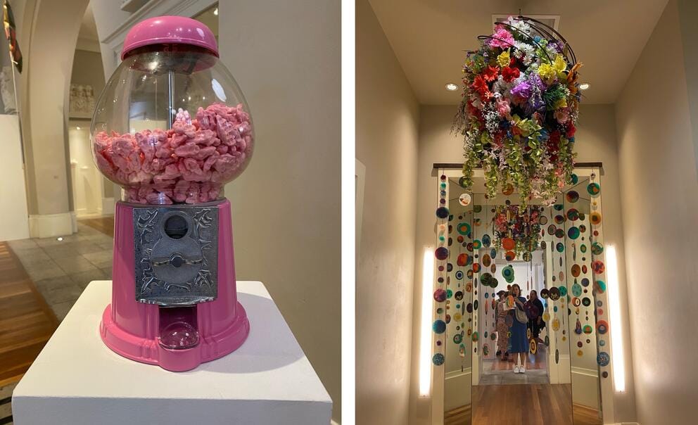 side by side photos of installed art, at left a pink gum ball machine, at right a chandelier of flower