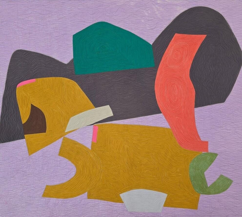 a quilt with abstract shapes in colors of lilac, orange and mustard