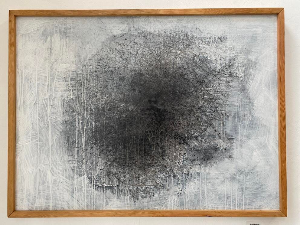 a painting that looks like a circular array of black squiggles with a white wash surrounding