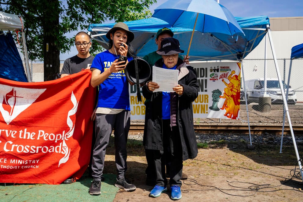 Activists read a letter outside the detention center